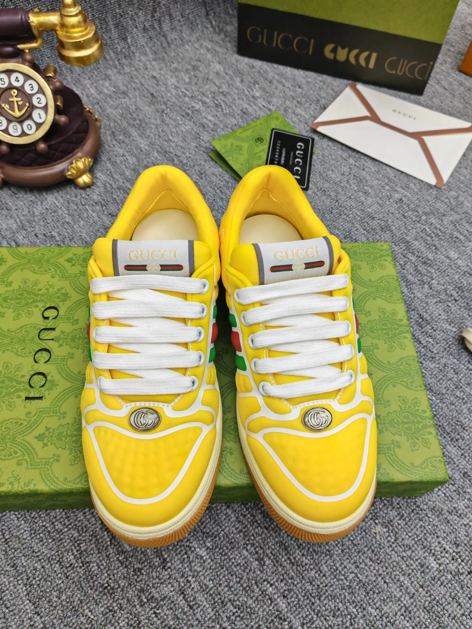 Factory price 600💰Screener series embellished web sneakers. This item is from the Gucci Lido series. Its design is inspired by the summer style and beach clubs of the Italian coast. The Screener series of sneakers draws inspiration from classic sneakers from the 1970s and takes its name from a special defensive move in sports. This shoe from the 2024 Pre-Fall collection is crafted from yellow rubber, a technical and malleable opaque material, with striped webbing on the sides and an embossed Gucci printed logo on the heel. Yellow rubber, opaque and technological in appearance. Red and green webbing decorated with metal Double G oval enamel details. Gucci printed embossed logo. Women 35-40, men 38-45, (men 38 and 45 need to be customized)